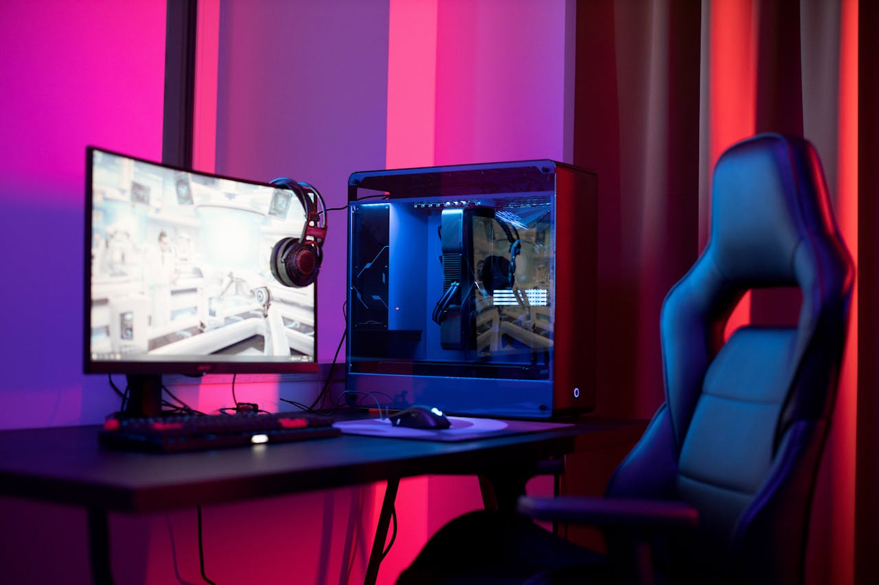 menu-09 A sleek gaming setup featuring a high-end PC, widescreen monitor, and ergonomic chair lit by neon lights.